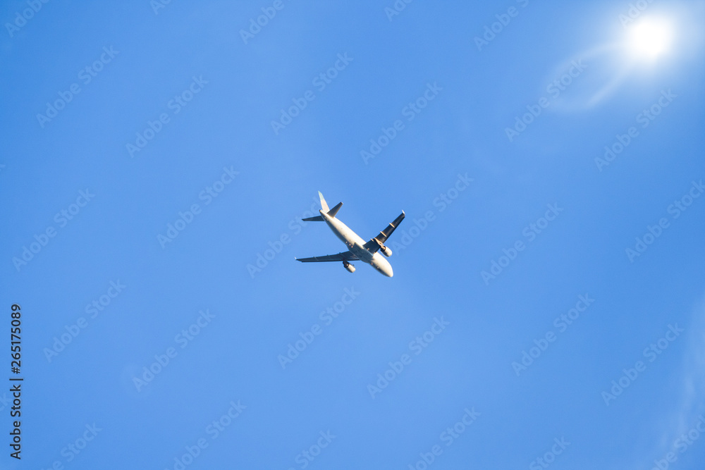 blue sky with plane and sun blue sky with plane and sun