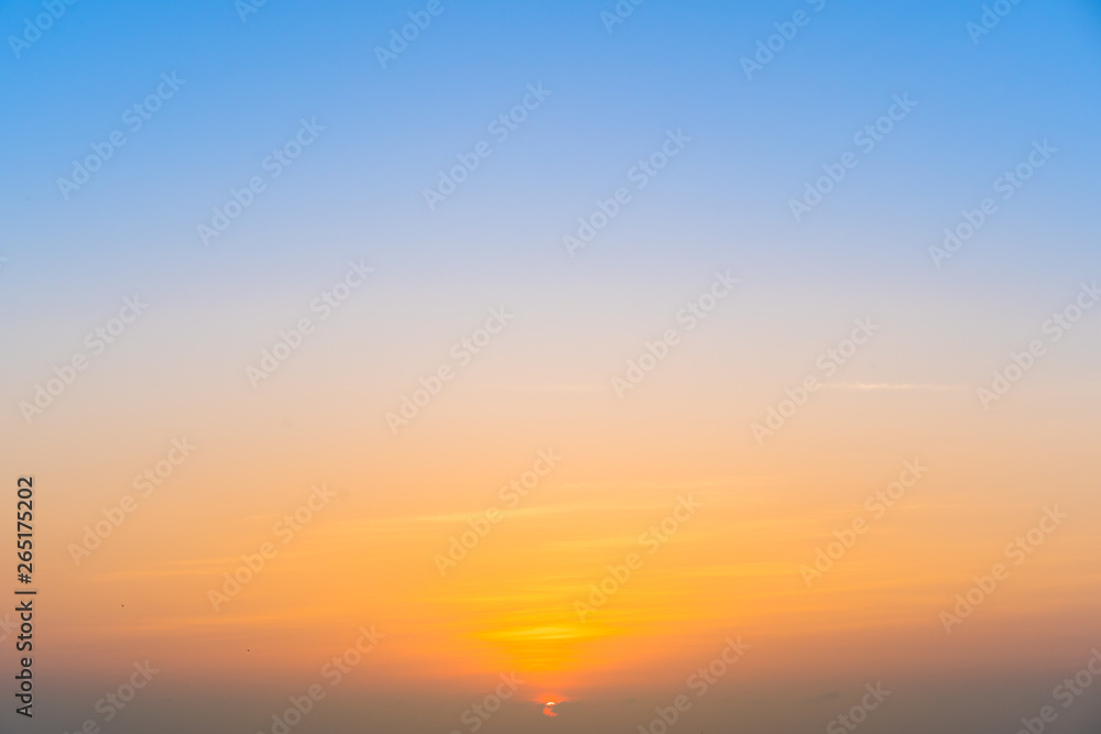 Beautiful the sunrise near the sky line, beautiful sky in blue and warm tone during the sunrise.  Sunrise background.