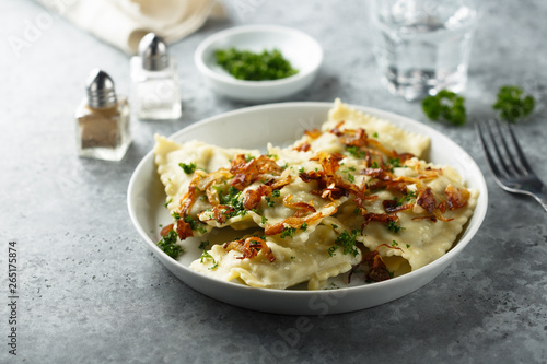 Traditional German dumplings with fried onion and herbs