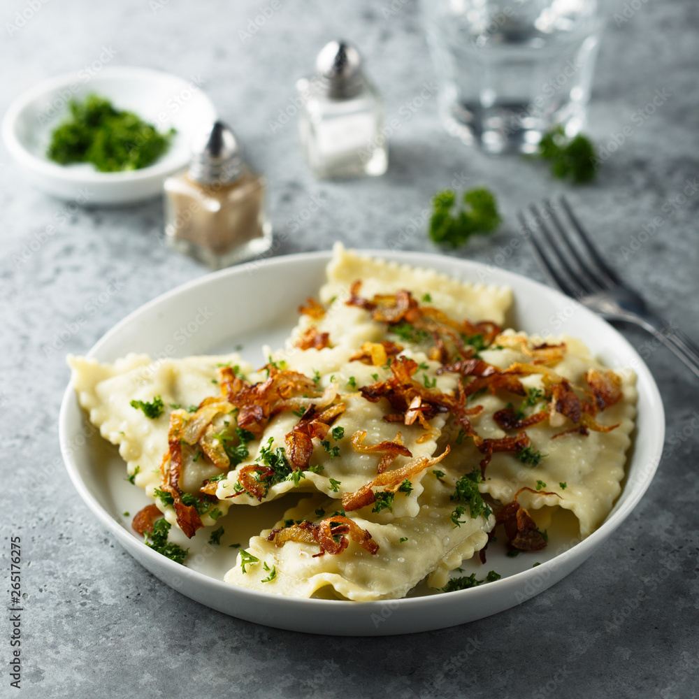 Traditional German dumplings with fried onion and herbs