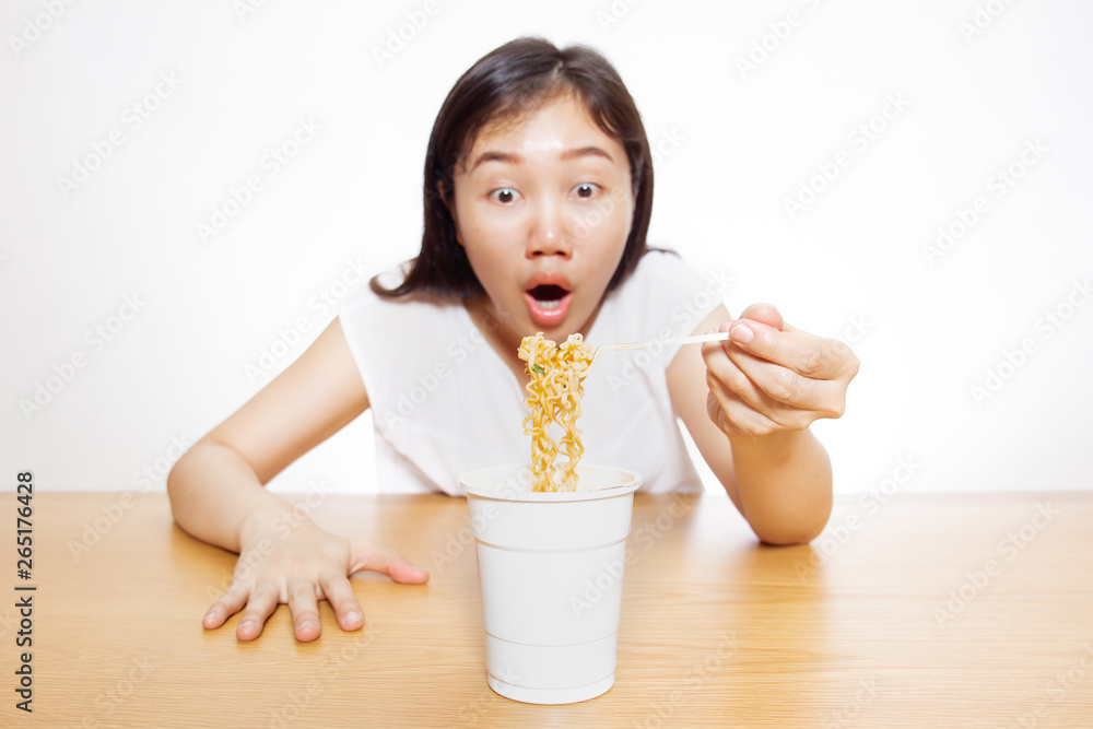 Asian girl enjoy eating delicious noodle close up on white background. Asian girl enjoy eating delicious noodle close up on white background.