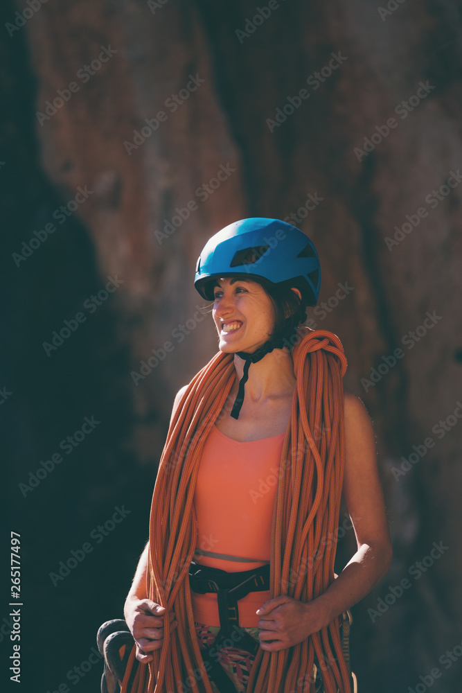 Climber in a helmet looks at a rock wall. Climber in a helmet looks at a rock wall.