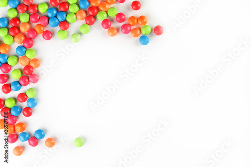 A rainbow of color from multicolored candies close-up, multi-colored glaze dragee on a white background © Alexander