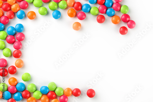 A rainbow of color from multicolored candies close-up, multi-colored glaze dragee on a white background