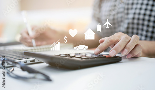 close up on mature woman pressing on calculator for making expense monthly and manage spending of life when retire such as home loan,insurance,savings,travel,health , lifestyle aged people concept photo