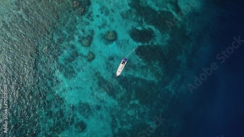 White motor boat in the open ocean, aerial view.