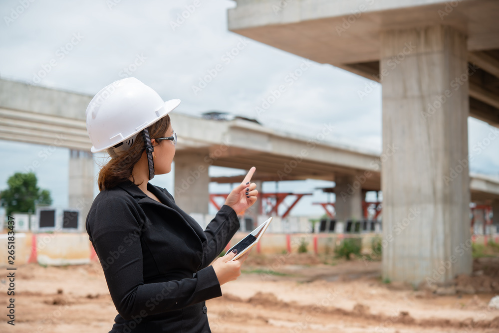 Engineer woman working at site of bridge under construction Engineer woman working at site of bridge under construction