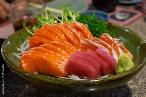 Raw salmon slice or salmon sashimi in Japanese style fresh serve with fresh wasabi.