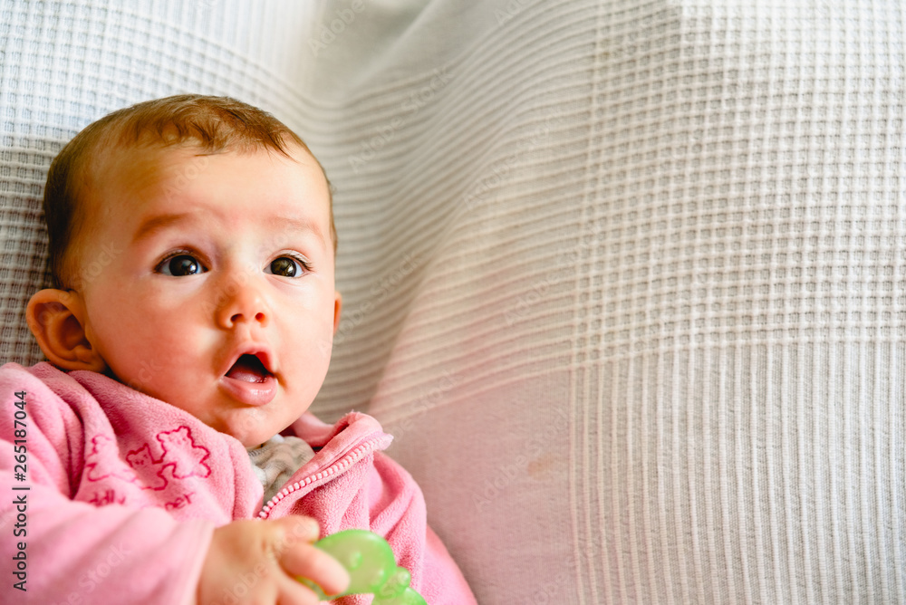 Adorable funny baby girl smiling with pink pajamas. Adorable funny baby girl smiling with pink pajamas.