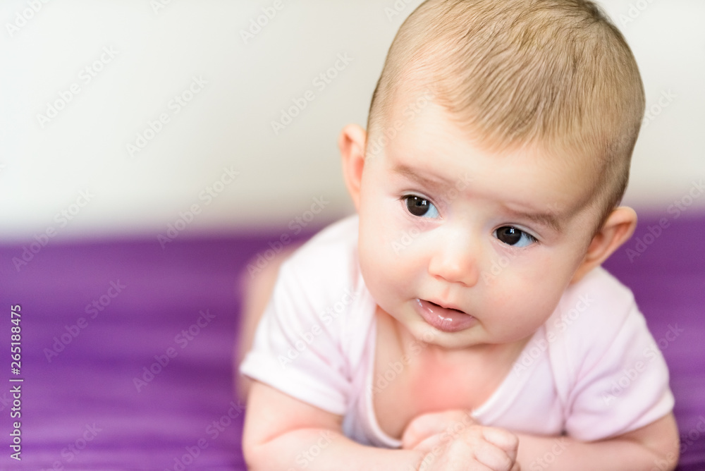 Nice baby girl smiling in her bed. Nice baby girl smiling in her bed.