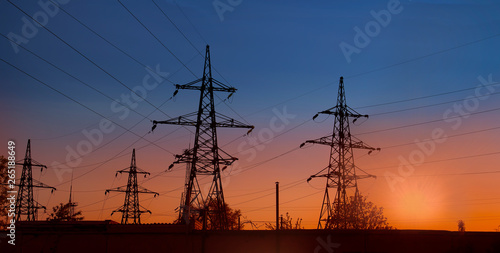 Photos Electricity pylon and lines at suncet in the evening, banner
