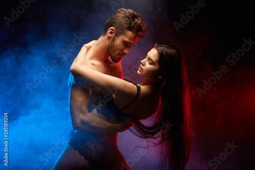 handsome sexy man holding his woman's waist and enjoying pastime with her. close up photo
