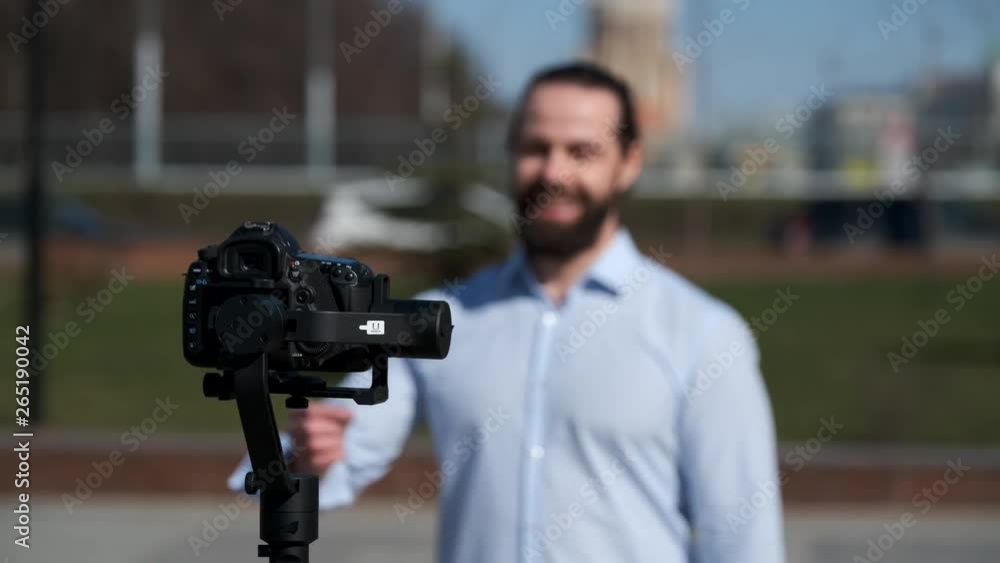 Young male blogger broadcasting video blog Young male blogger broadcasting video blog