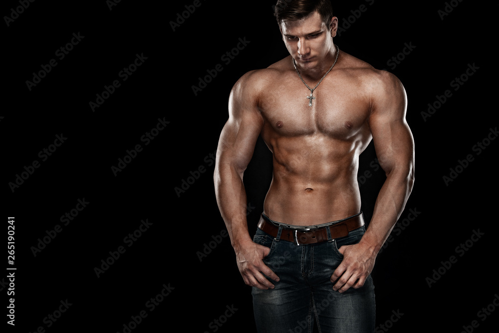 Bodybuilding competitions on the scene. Man sportsmen physique and athlete. Black background with lights.