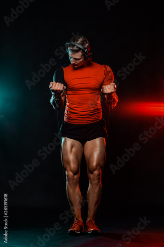 Muscular fitness sports man  atlete with dumbbell in fitness gym. Energy and power.