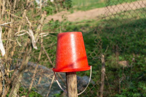 red bucketful on pillar © Sergey