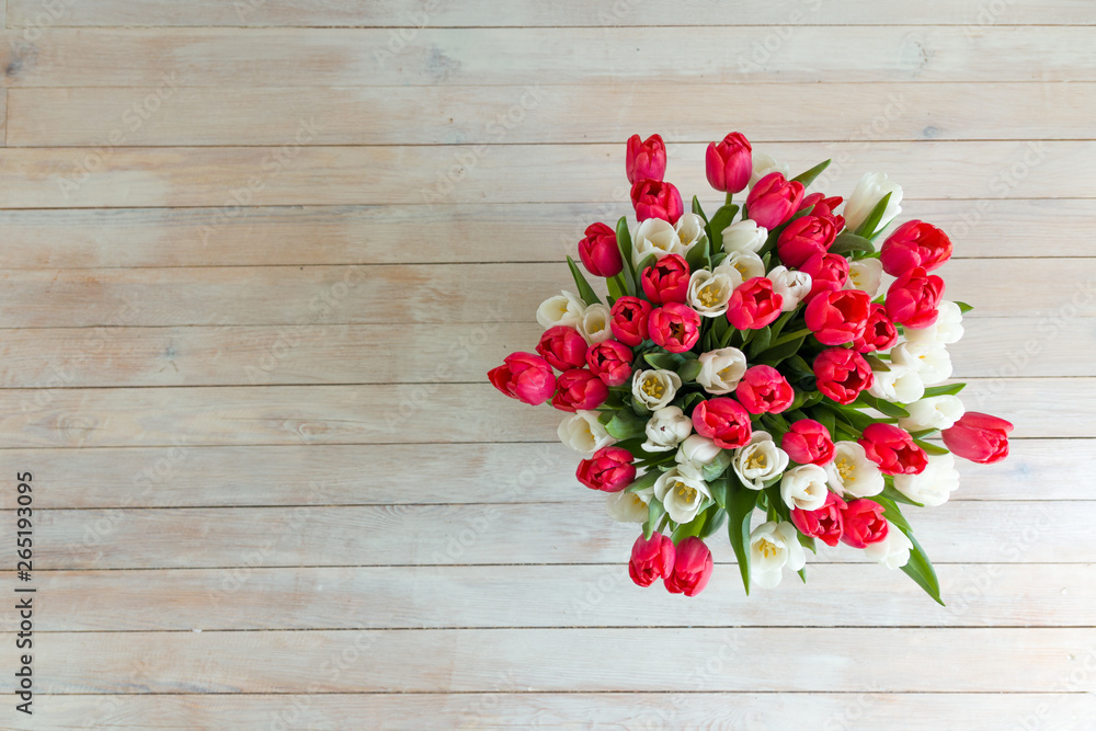 Fototapeta premium Tulips flowers a bouquet of flowers wooden background