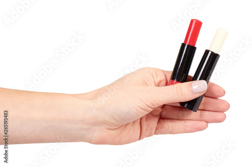 Hand with red and white balm lipstick  lips care and beauty