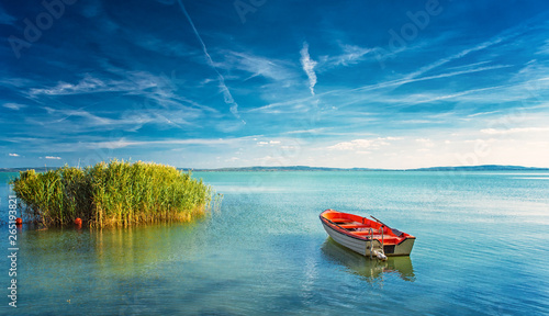 Lake Balaton with a red boat on a sunny day photo