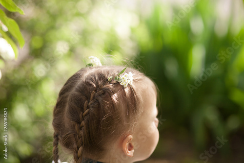 braids hairstyle with flowers close up