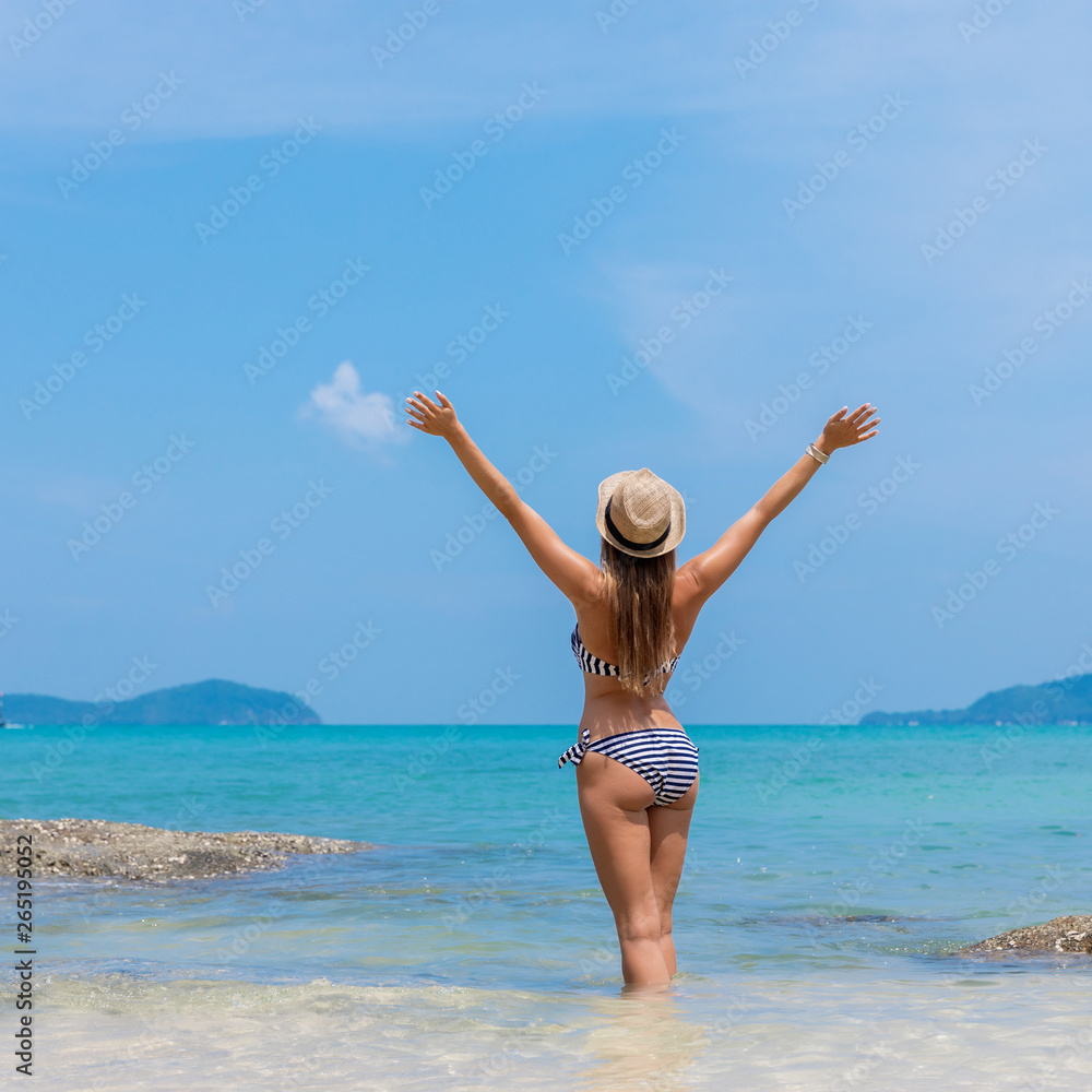 Young woman on exotic white beach near the sea Young woman on exotic white beach near the sea