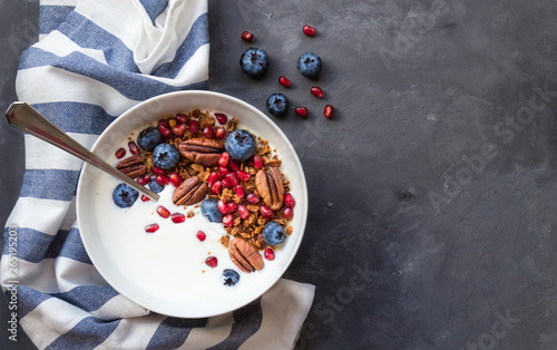 Granola, muesli with pomegranate seeds, blueberries and yogurt