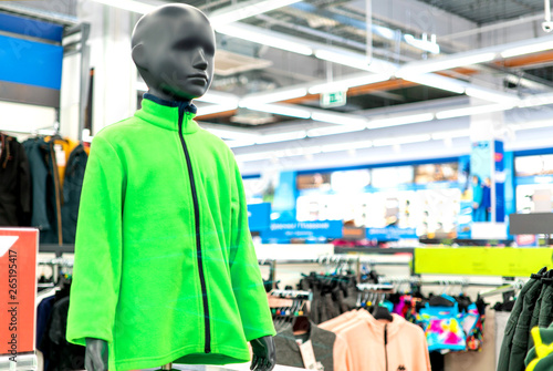 mannequin in a sports shop. children's fleece jacket green dressed on a mannequin