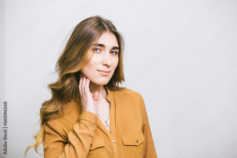 Portrait of beautiful woman with curly long hair on white background. Makeup, fashion, beauty Portrait of beautiful woman with curly long hair on white background. Makeup, fashion, beauty