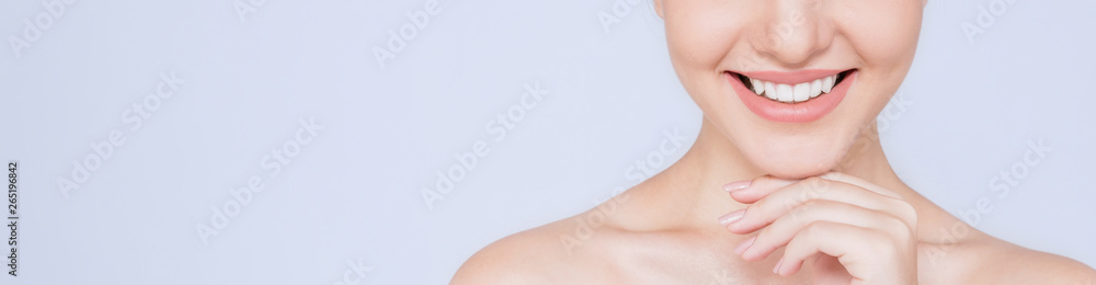 Obraz premium Portrait of attractive caucasian woman with beautiful teeth and skin isolated on white, close up young beautiful face smiling girl with her hand touching her chin. Healthy teeth dental care concept