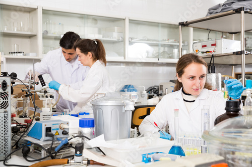 Female chemist writing results of experiments