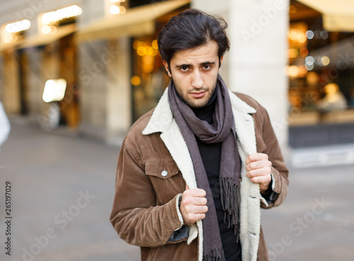 Man in coat standing at the street at Christmas time photo