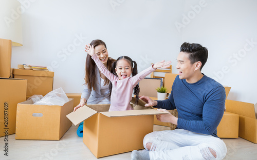 Asian family father mother daughter girl packing cardboard box moving to new house, online marketing e-commerce unpacking stuff delivery. Lifestyle happy asian family together relocation concept. © paulaphoto
