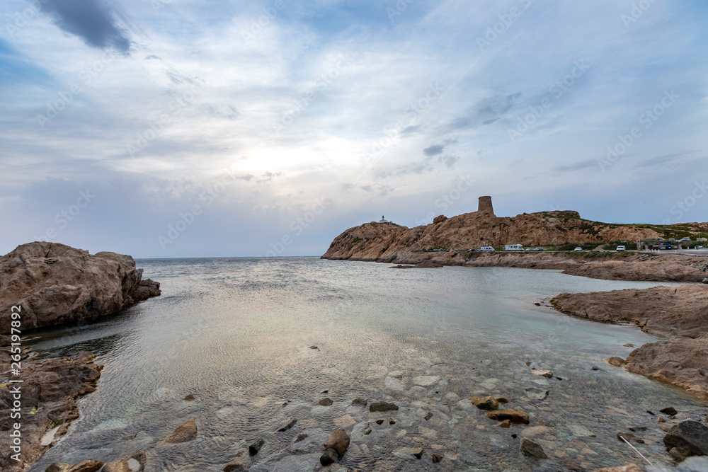 L'Île-Rousse with Torra di a Petra and lighthouse at twilight, Corsica, France