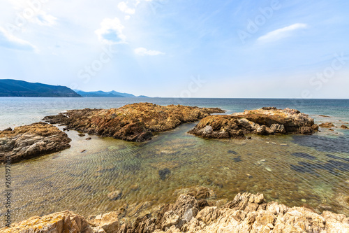 jagged red rocks on the coast of the Desert des Agriates at Ostriconi in the Balagne region of Corsica, France