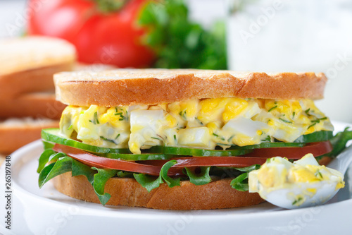 Sandwich with egg salad, lettuce, tomatoes, cucumbers and dill. Gourmet Breakfast. Selective focus photo