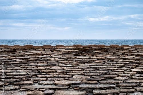typical stone roofs of Erbalunga with the sea in the background. Cap Corse, Corsica, France, Europe
