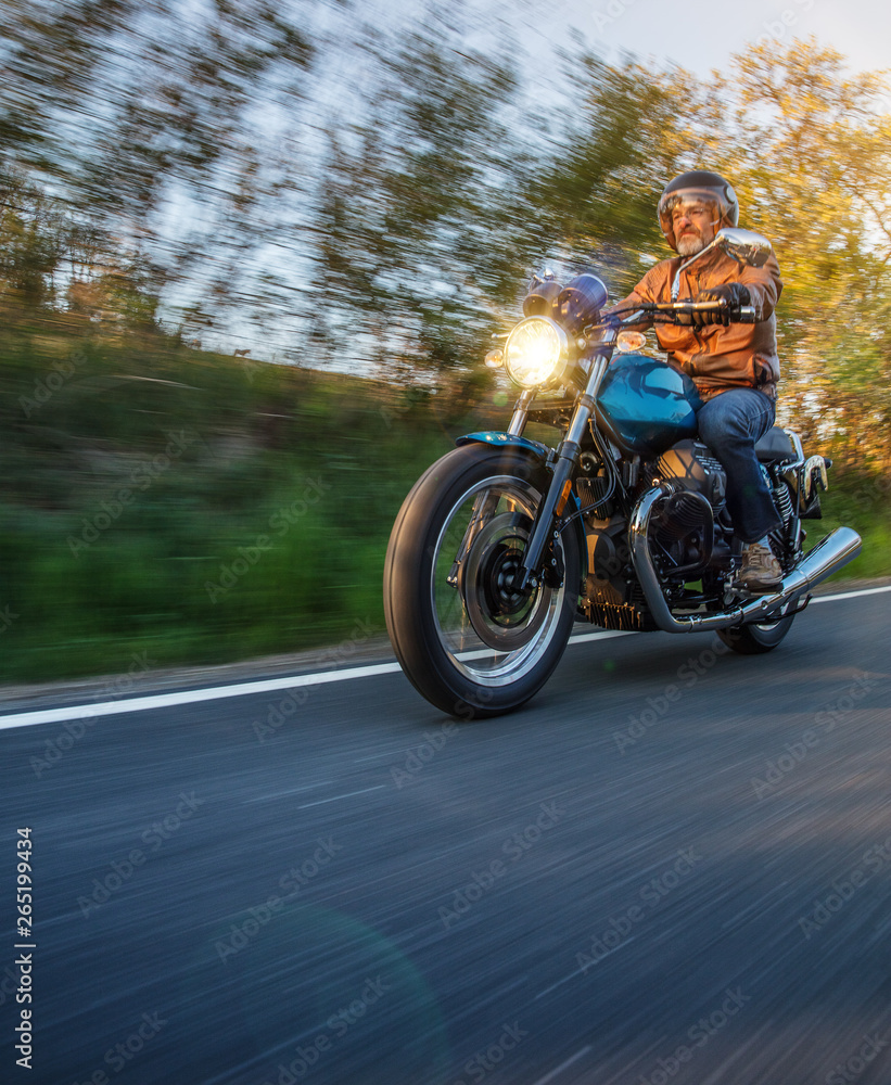 Moto racer riding on mountain road, travel to Europe.