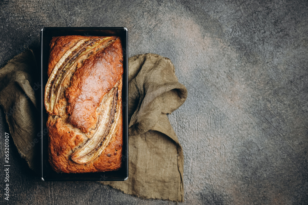 Banana bread with nuts, honey and mint on a dark background. Banana bread with nuts, honey and mint on a dark background.