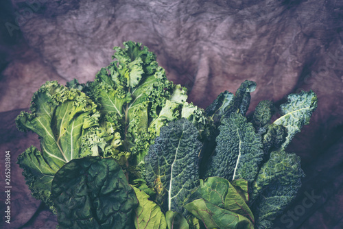 Green leafy vegetables on vintage background photo