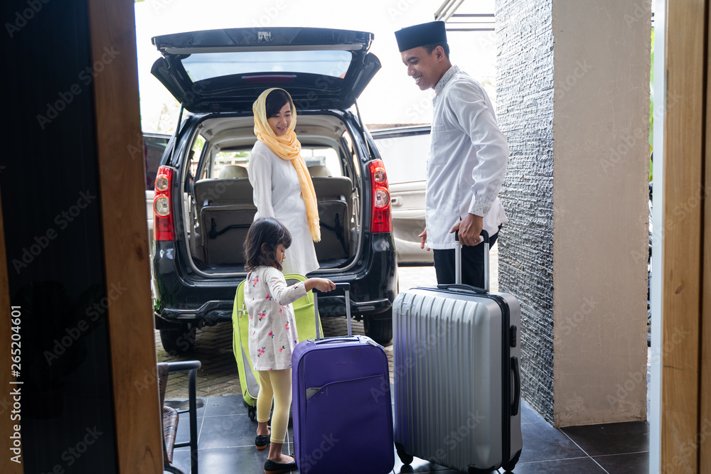 asian muslim family with suitcase prepare to go. concept of family travelling for eid mubarak celebration asian muslim family with suitcase prepare to go. concept of family travelling for eid mubarak celebration