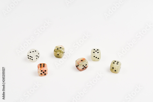 Dices made of natural stone on a white background. Copy space. Gaming.