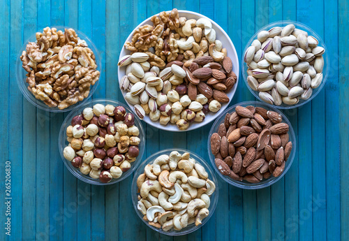 Healthy food. Nuts mix assortment on texture top view. Collection of different legumes for background image close up nuts  pistachios  almond  cashew nuts  peanut  walnut. image
