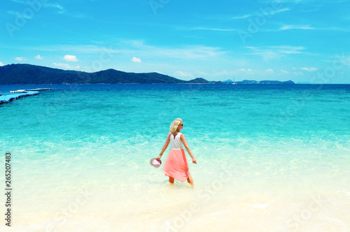 Seascape with a young woman on vacation, tropical landscape on a bright sunny day in Thailand islands