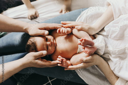 baby in the hands of mom and dad