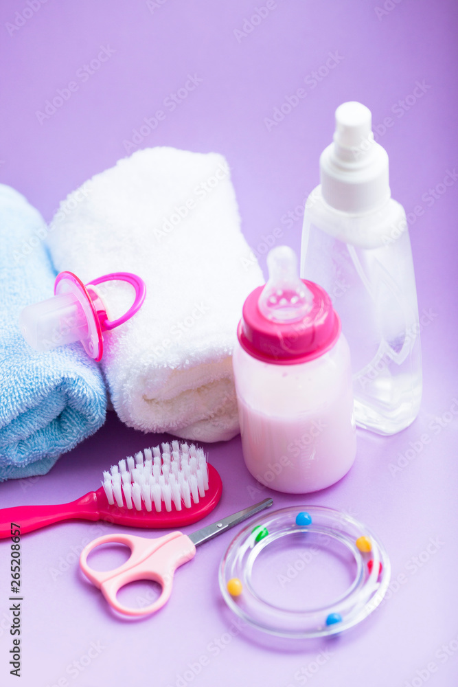 Newborn baby story. Towels and children's toys, scissors, baby bottle, nipple, hairbrush on white background Newborn baby story. Towels and children's toys, scissors, baby bottle, nipple, hairbrush on white background