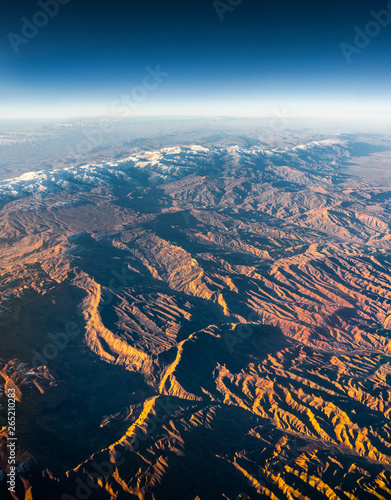 Aerial View from an Airplane. Flying above Beautiful Land at Sunrise.