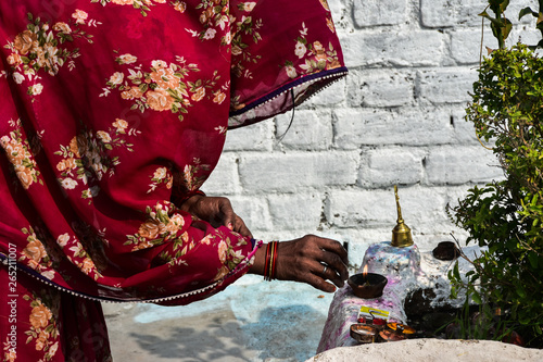 woman in sari who pray in front of the temple in Kajuraho - India photo