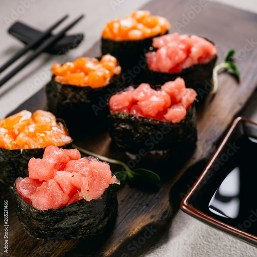Seafood delicatessen gunkan maki sushi rolls on wooden plate. Different gourmet snacks. Luxury lifestyle, expensive food, restaurant menu