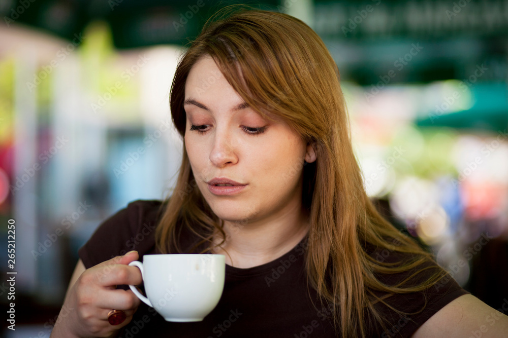 Young woman drinking hot beverage Young woman drinking hot beverage