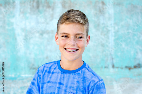 Portrait of a handsome young teen boy smiling with braces